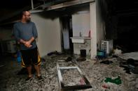 An Israeli inspects damage to an apartment in the southern town of Ashkelon, hit by a rocket fired from the Gaza Strip on November 12, 2018