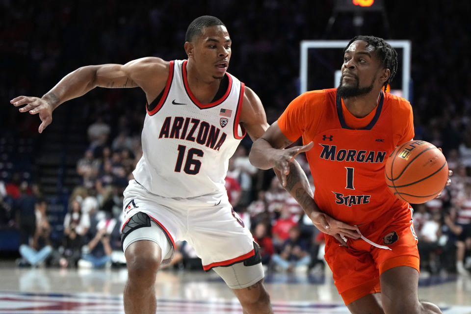 Morgan State guard Wynston Tabbs (1) drives against Arizona forward Keshad Johnson during the first half of an NCAA college basketball game Monday, Nov 6, 2023, in Tucson, Ariz. (AP Photo/Rick Scuteri)