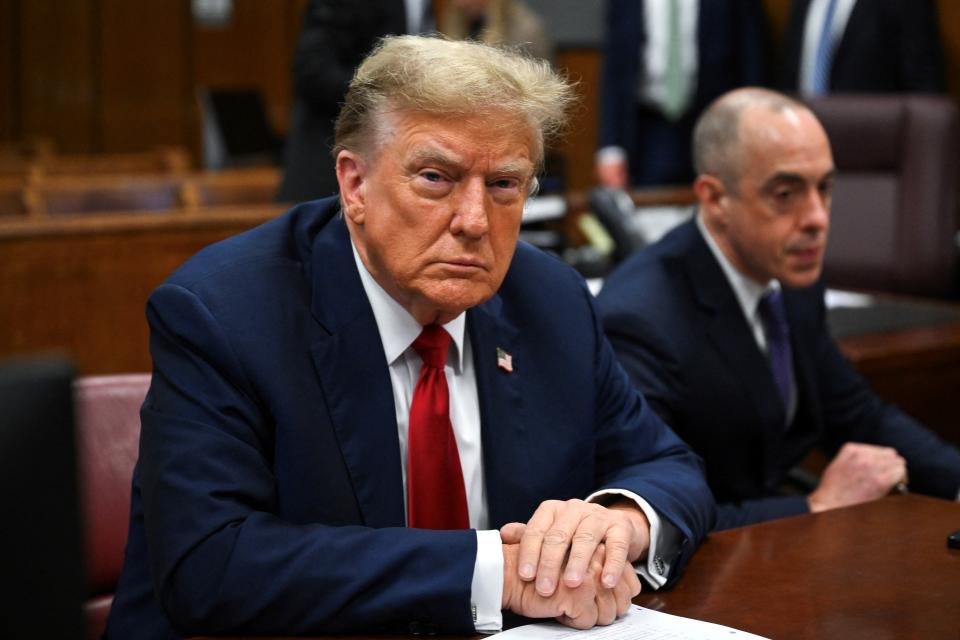 Trump sits next to his lawyer at the defense table Monday. (Angela Weiss/Pool via AFP via Getty Images)
