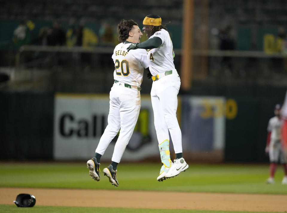 Oakland Athletics' Lawrence Butler (4) celebrates with Zack Gelof (20) after hitting a single to drive in the winning run against the Washington Nationals duringi the 10th inning of a baseball game in Oakland, Calif., Friday, April 12, 2024. (AP Photo/Tony Avelar)