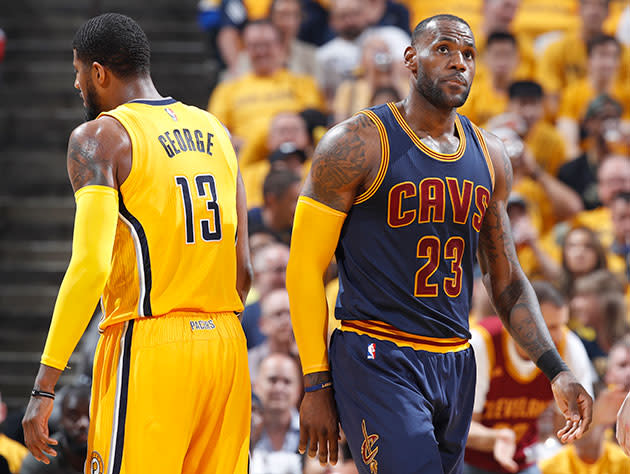 LeBron James moves past Paul George. (Getty Images)