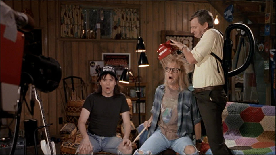 <p>The Wayne’s World cable show is basically a series of idiotic escapades designed to terrify Garth to his very core. One episode sees him given a haircut by a new invention called a ‘Suck-Cut’: a cross between a vaccuum cleaner and a barber. It doesn’t end well for Garth: “Turn it off man, turn it off! It’s sucking my will to live! Oh, the humanity!” (Credit: Paramount Pictures) </p>