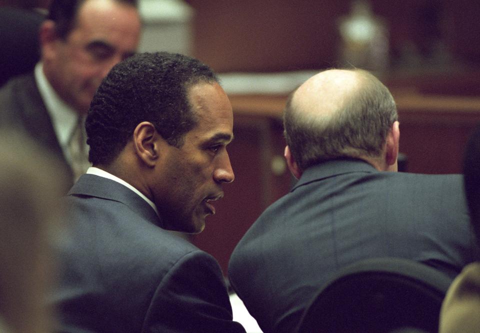O.J. Simpson talks to Francis Bailey Jr. during Simpson's double homicide case at the Clara Foltz Criminal Justice Center in Los Angeles, May 26, 1995.