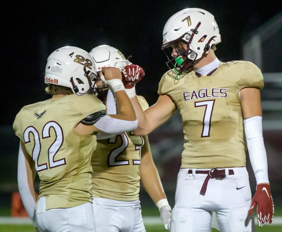 Dunlap’s Mack Sutter (7) bumps fists with teammates Blake Dietz (22) and Joseph Weeks as the Eagles battled Galesburg on the opening night of high school football Friday, Aug. 30, 2024 at Dunlap High School.