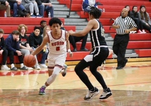 Alex Tejeda-Walker goes to the basket for New Boston Huron during a 56-41 win over Taylor Monday night. Tejada-Walker scored a career-high 16 points and grabbed 10 rebounds.