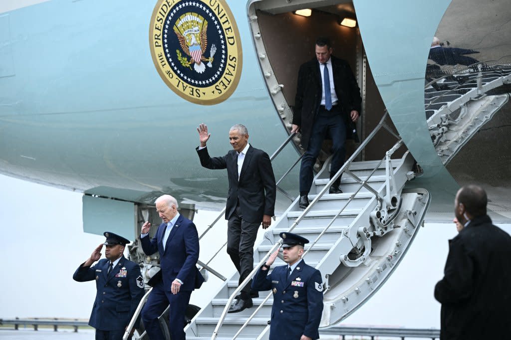 President Joe Biden (front) and former President Barack Obama step off Air Force One upon arrival at John F. Kennedy Airport in New York for a March 28 fundraiser. (Photo by Brendan Smialowski/AFP via Getty Images)