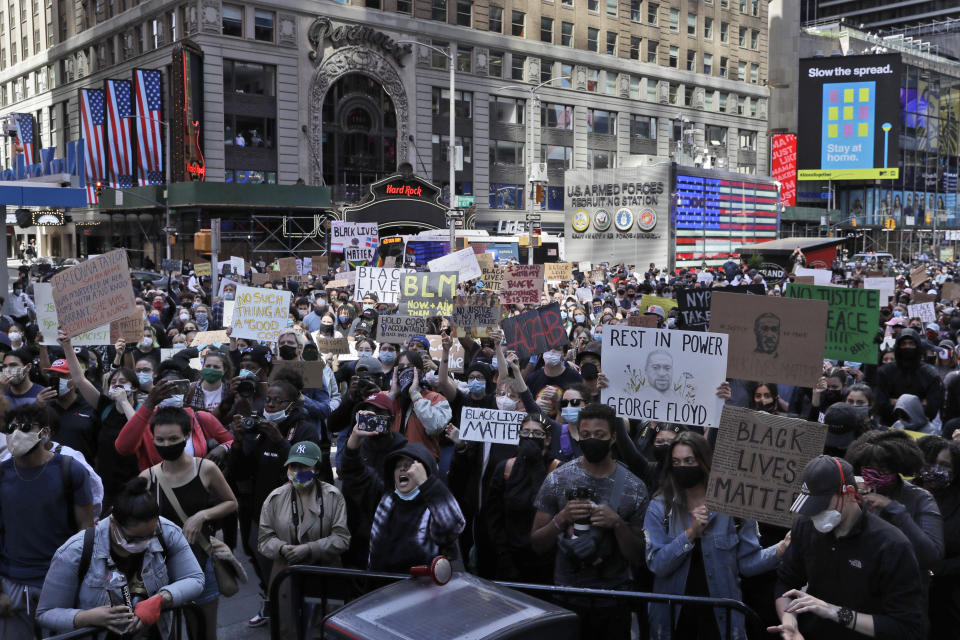 Protesters gather in Times Square before marching through the streets of Manhattan in New York, Monday, June 1, 2020. New York City imposed an 11 p.m. curfew Monday as the nation's biggest city tried to head off another night of destruction erupting amid protests over George Floyd's death. (AP Photo/Seth Wenig)