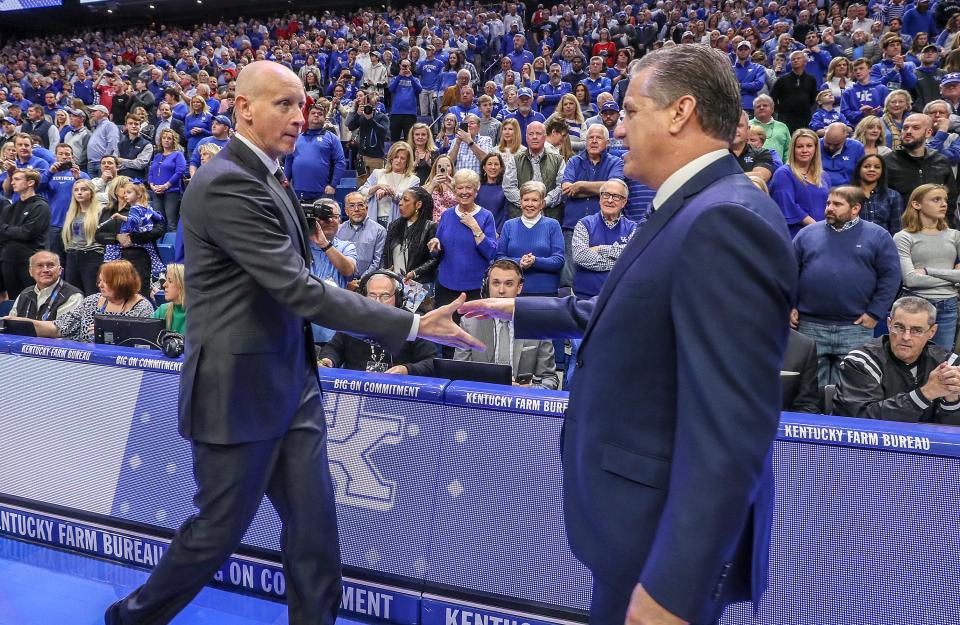 Coach Chris Mack and John Calipari meet at mid court before the game at Rupp Arena.December 28, 2019