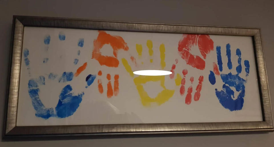 A photo of hand prints made out of paint, made by Lauren and her family at Alder Hey Hospital in Liverpool, England.