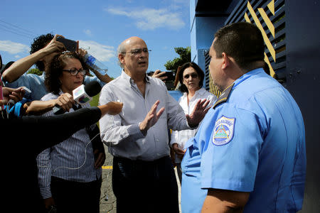 Journalist Carlos Fernando Chamorro, critic of the government of President Daniel Ortega speaks with a police officer during his arrival at police headquarters in Managua, Nicaragua December 15, 2018. REUTERS/Oswaldo Rivas