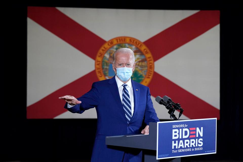 The Florida state flag hands behind Democratic presidential candidate former Vice President Joe Biden as he speaks at Southwest Focal Point Community Center in, Pembroke Pines, Fla., Tuesday Oct. 13, 2020.