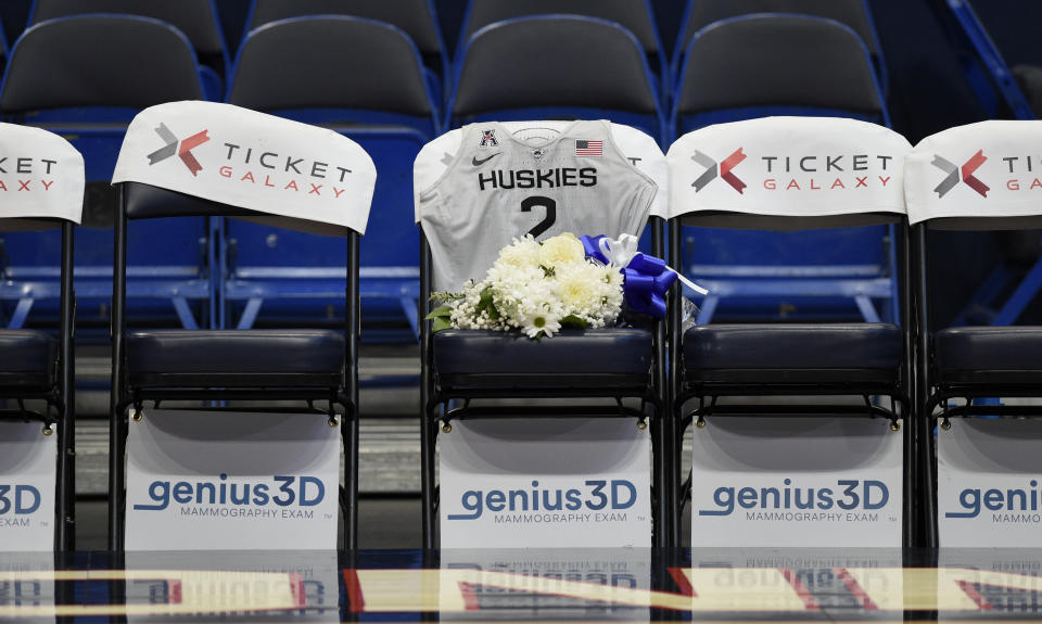 A seat with a jersey and flowers is reserved in memory of Gianna Bryant before an exhibition basketball game in the first half of a basketball game against the US, Monday, Jan. 27, 2020, in Hartford, Conn. Bryant was going to play at Connecticut and head to the WNBA. That was the plan. Her promising life came to a shocking, sudden and sad end Sunday, Jan. 26, 2020 along with her father Kobe. They died in a helicopter crash in California along with seven others. (AP Photo/Jessica Hill)