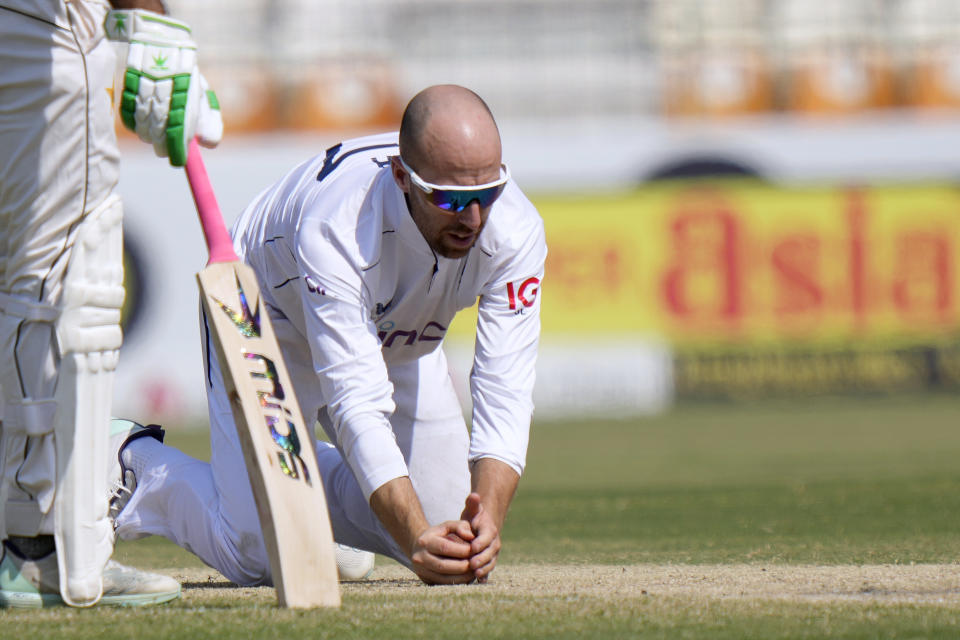 England's Jack Leach takes the catch of Pakistan's Shaheen Shah Afridi during the fifth day of the first test cricket match between Pakistan and England, in Multan, Pakistan, Friday, Oct. 11, 2024. (AP Photo/Anjum Naveed)