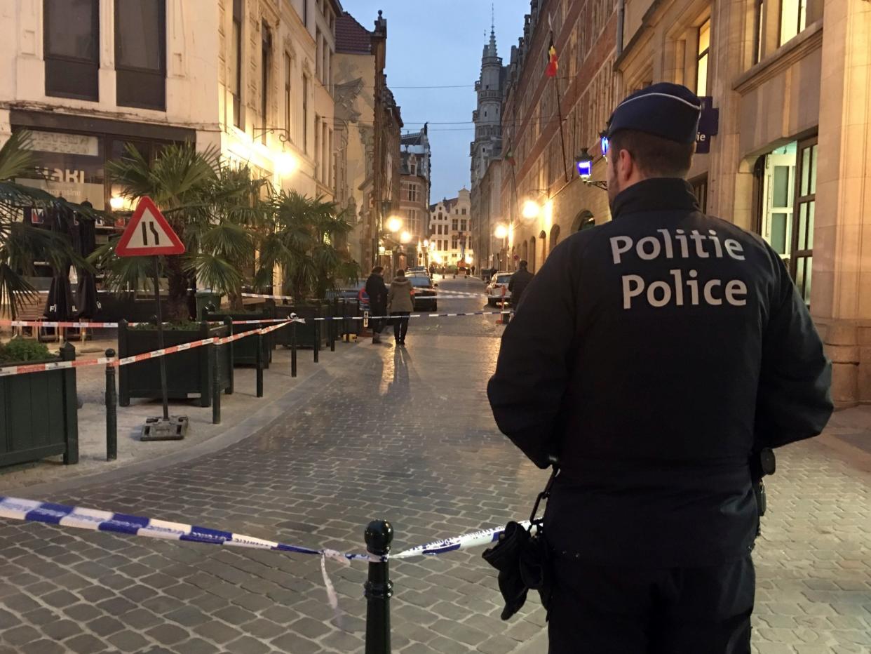 A police officer stands behind police tape during investigations at the scene of a stabbing in the centre of Brussels: AP/Sylvain Plazy