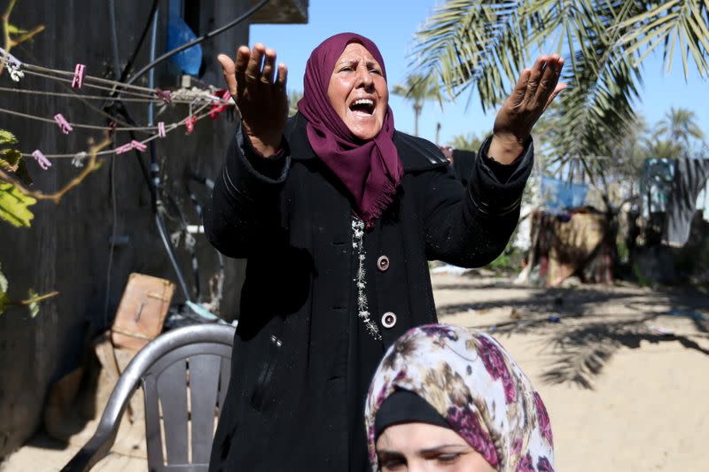 Relatives of three Palestinian fishermen from Allaham family mourn during their funeral in Khan Younis in the southern Gaza Strip