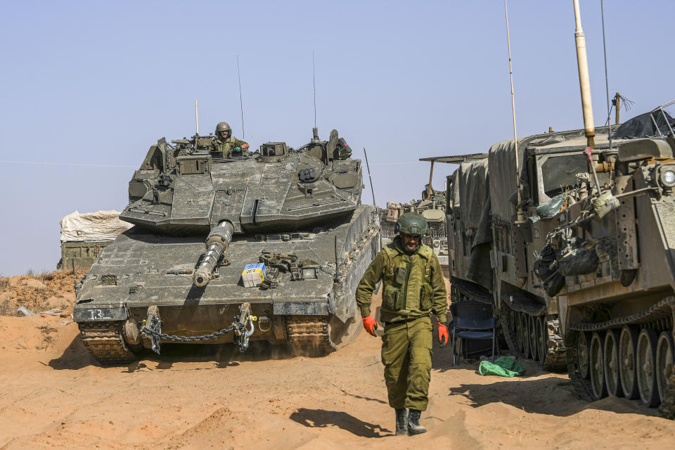 Israeli soldiers drive a tank at a staging ground near the border with the Gaza Strip, in southern Israel, Sunday, May 5, 2024. (AP Photo/Tsafrir Abayov)