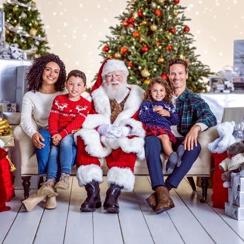 In this image promoting the Santa Photo Experience at Simon Malls locations, a family sits with Santa Claus. Families will also have the option to practice social distancing, and booking your reservation online before visiting is highly recommended.