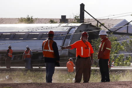 Officials survey the site of a derailed Amtrak train in Philadelphia, Pennsylvania May 13, 2015. REUTERS/Mike Segar