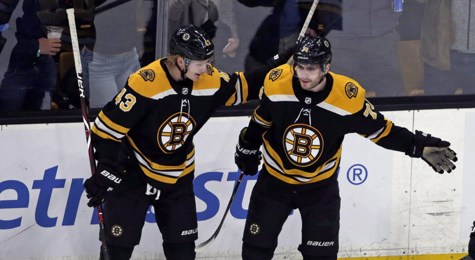 Boston Bruins left wing Jake DeBrusk (74) celebrates his goal with teammates Danton Heinen (43) and David Krejci (46) in the third period of an NHL hockey game against the Calgary Flames, Thursday, Jan. 3, 2019, in Boston. The Bruins won 6-4. (AP Photo/Elise Amendola)