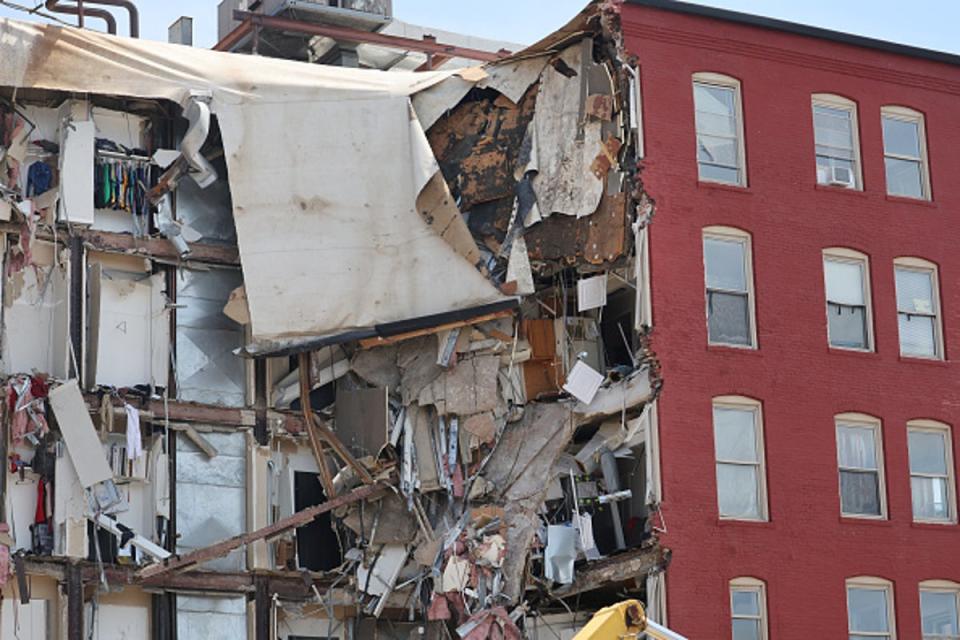 Debris hangs from a six-story apartment building after collapse on May 29 (Getty Images)