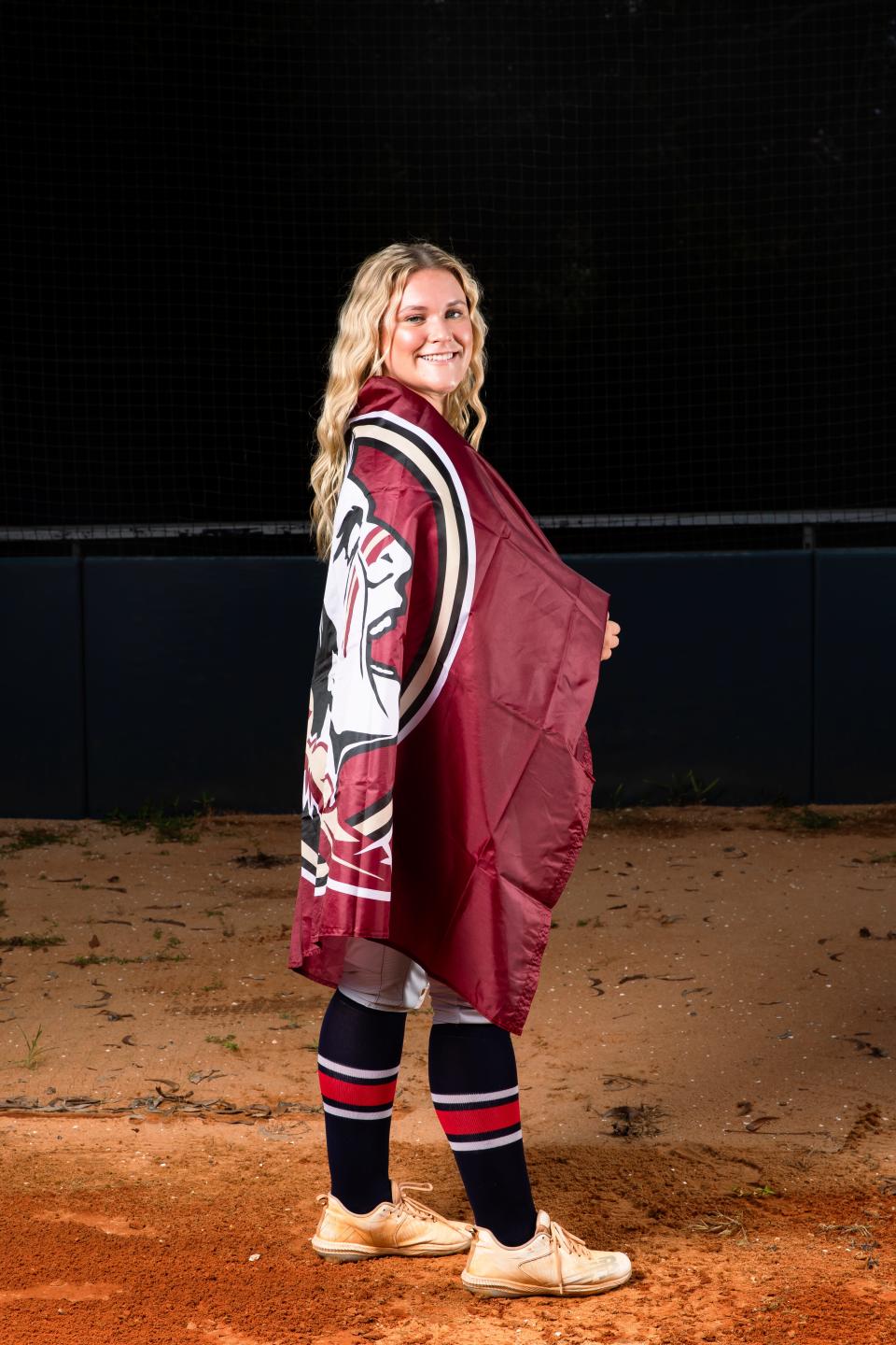 Oxbridge Academy's Bella Ruggiero poses with a Florida State flag on a recruiting visit. Ruggiero is signed to join the Seminoles in the Class of 2024.