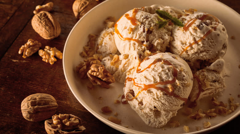 Ice cream drizzled in maple syrup and walnuts