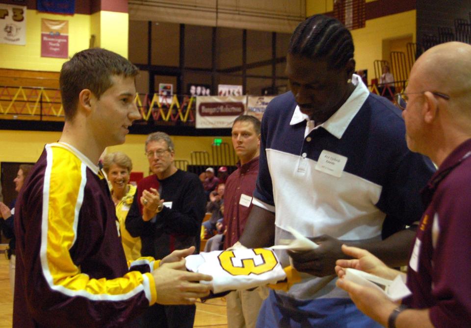 Bloomington North junior Trent Beane presents Djibril Kante with his jersey as a part of the 10th Anniversary celebration of North's 1997 boys basketball state championship, before the home game against Lawrence Central on Saturday, Jan. 20, 2007.