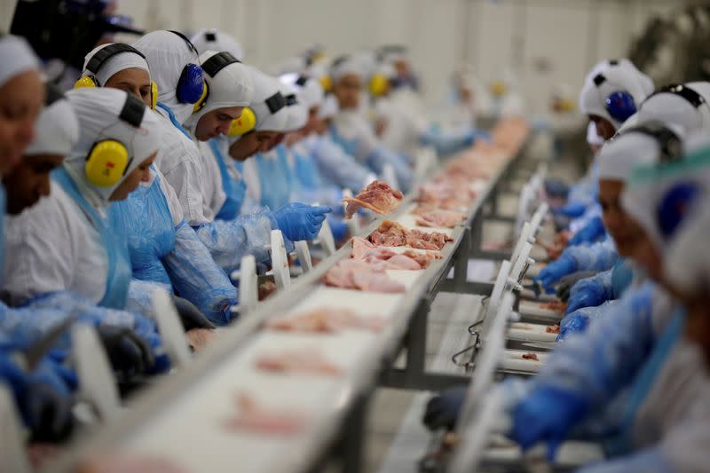 FILE PHOTO: Employees are seen during a technical visit of Brazil's Agriculture Minister Blairo Maggi at the Brazilian meatpacker JBS SA in Lapa