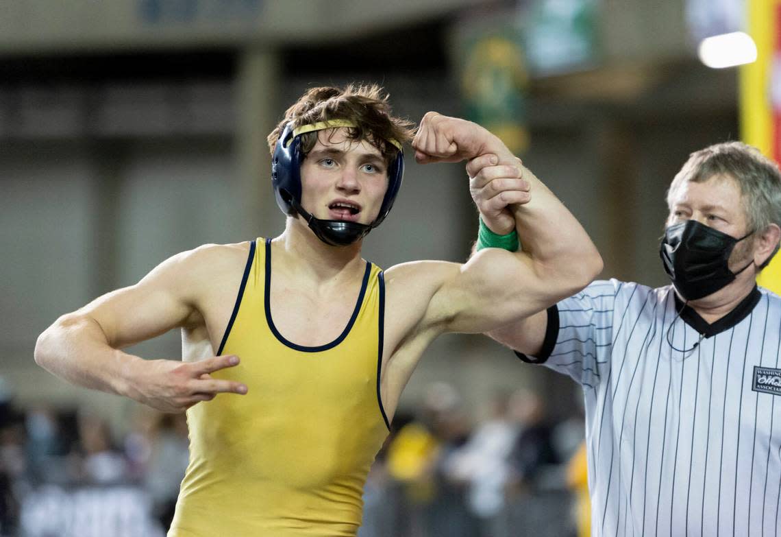 Kelso’s Ethan Freund has his hand raised after winning the 132-pound championship at Mat Classic XXXIII on Saturday, Feb. 19, 2022 at the Tacoma Dome.