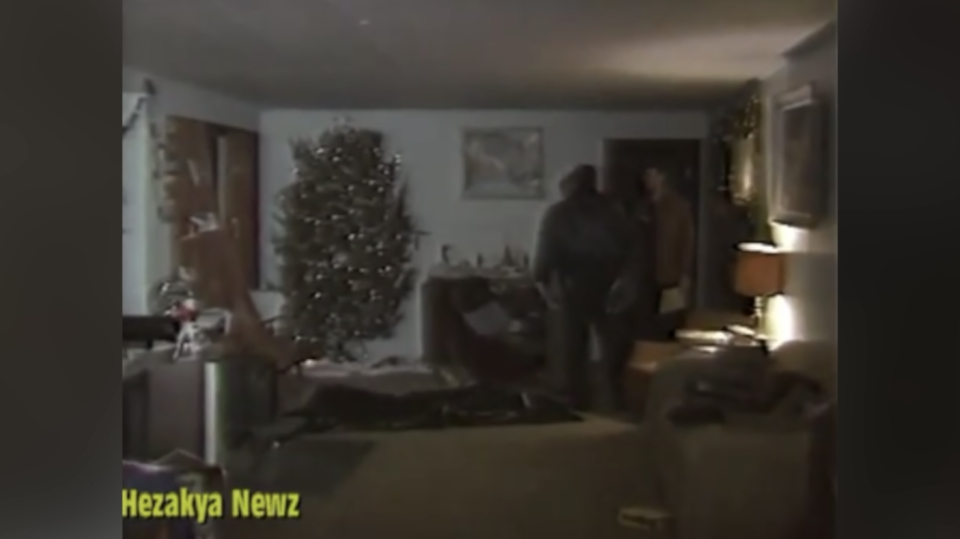 Police are seen standing near a covered body under the Simmons' Christmas tree. Source: Youtube