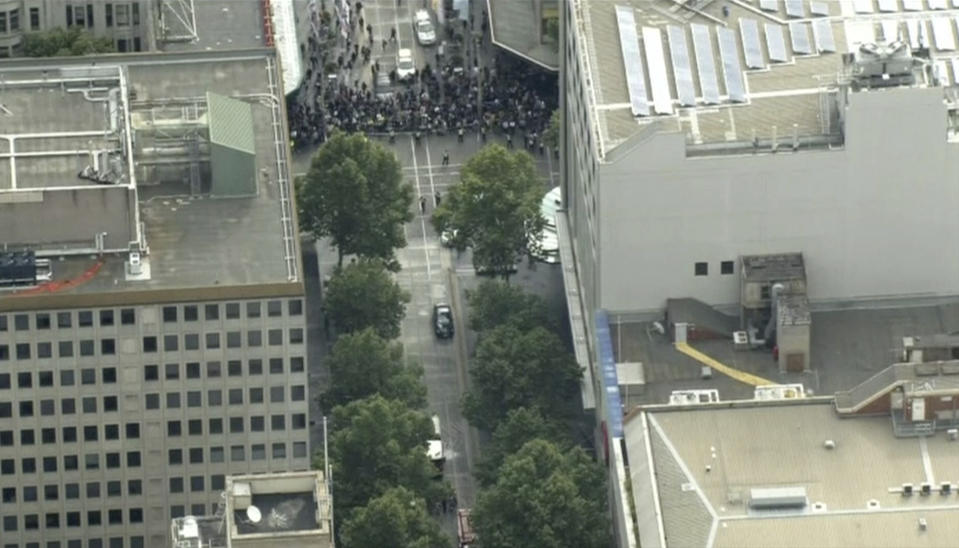 This image made from video shows police cordon in Melbourne, Australia, Friday, Nov. 9, 2018. Police shot a knife-wielding man Friday after he fatally stabbed one person and injured two others in the center of Australia's second-largest city, police said. (Australian Broadcasting Corporation via AP)