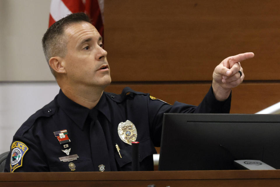 Coral Springs police officer Michael Leonard points out Nikolas Cruz in court. Leonard was the officer who arrested the defendant. Marjory Stoneman Douglas High School shooter Nikolas Cruz is being tried in the penalty phase of his trial at the Broward County Courthouse in Fort Lauderdale on Thursday, July 21, 2022. Cruz previously plead guilty to all 17 counts of premeditated murder and 17 counts of attempted murder in the 2018 shootings. (Mike Stocker/South Florida Sun Sentinel via AP, Pool)