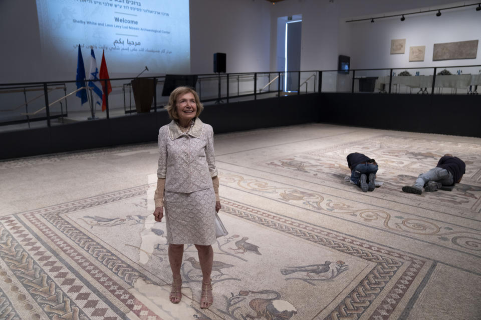 Shelby White poses for a photo on a restored Roman-era mosaic during the inauguration of the Shelby White & Leon Levy Lod Mosaic Archaeological Center, in Lod, central Israel, Monday, June 27, 2022. A series of well-preserved ancient Roman mosaics have returned home to the central Israel city of Lod after more than a decade touring the world's most prominent museums. Israel on Monday inaugurated a new museum to house the artworks that once adorned a Roman-era villa. Shelby is one of the donors of the museum. (AP Photo/Oded Balilty)