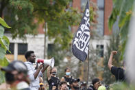 A man speaks to Black Lives Matter protesters, Friday, Sept. 25, 2020, in Louisville. Breonna Taylor's family demanded Friday that Kentucky authorities release all body camera footage, police files and the transcripts of the grand jury hearings that led to no charges against police officers who killed the Black woman during a March drug raid at her apartment. (AP Photo/Darron Cummings)