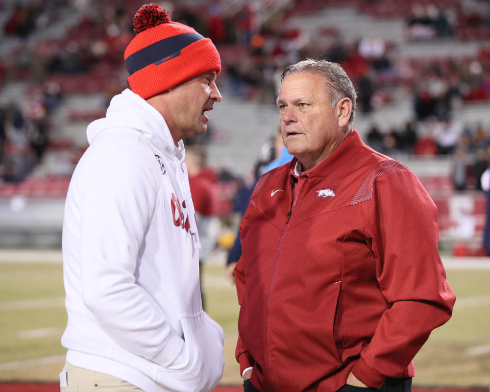 Nov 19, 2022; Fayetteville, Arkansas, USA; Ole Miss Rebels head coach Lane Kiffin talks to Arkansas Razorbacks head coach Sam Pittman prior to the game at Donald W. Reynolds Razorback Stadium. Mandatory Credit: Nelson Chenault-USA TODAY Sports