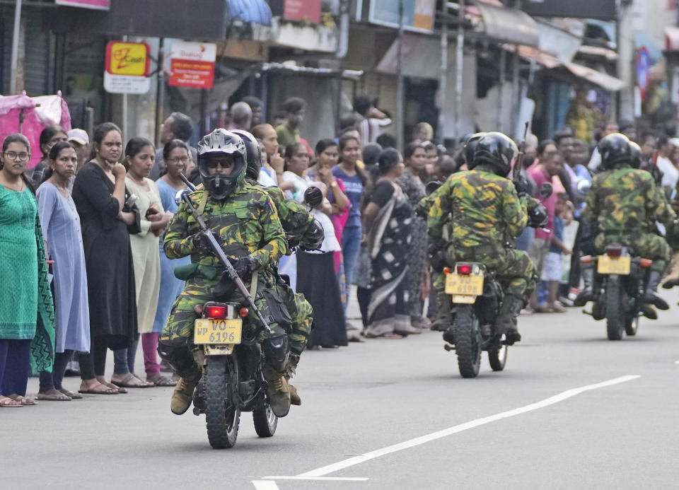 Sri Lankan policemen patrol on the motorcycles during a silent protest march by the Catholics to mark the fourth year commemoration of the 2019, Easter Sunday bomb attacks on their Churches, in Colombo, Sri Lanka, Friday, April 21, 2023. Thousands of Sri Lankans held a protest in the capital on Friday, demanding justice for the victims of the 2019 Easter Sunday bomb attacks that killed nearly 270 people. (AP Photo/Eranga Jayawardena)