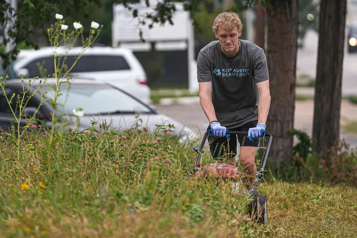 Henry Cudzilo mows grass during a community cleanup day at San Jose Cemetery in East Austin on Saturday, April 20, 2024.