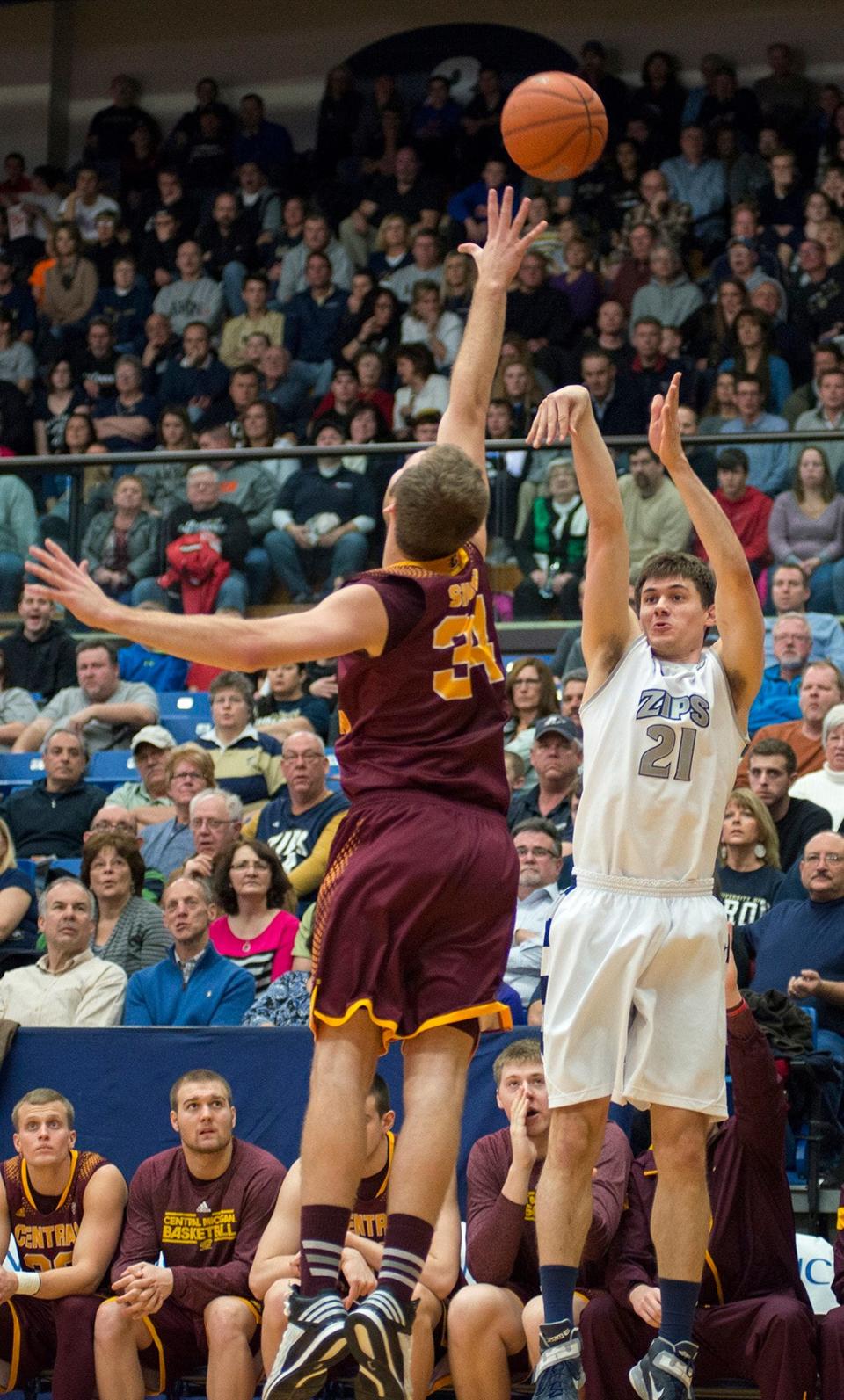 The University of Akron's Reggie McAdams shoots a 3-pointer over Central Michigan's John Simons at Rhodes Arena, Saturday, Jan. 17, 2015.