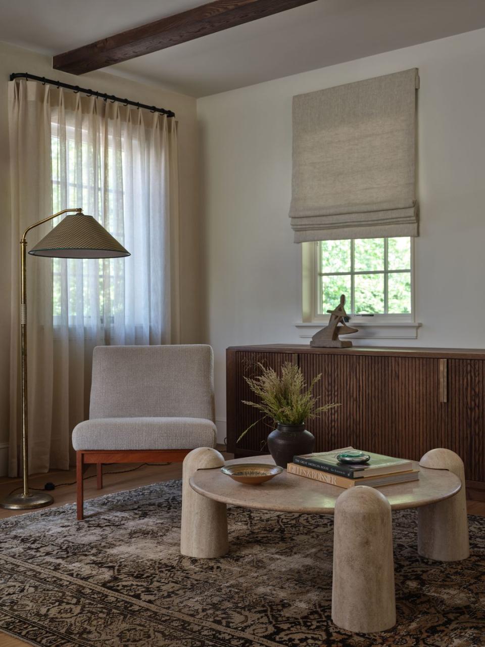 a living room with a table and chairs