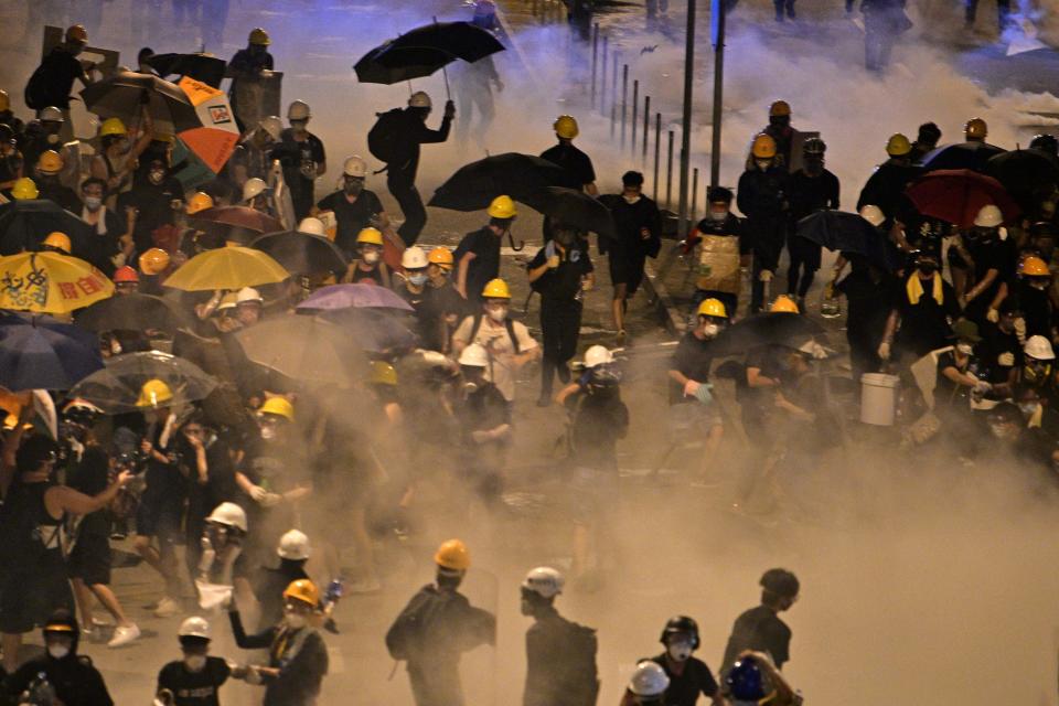 Police fire tear gas at protesters near the government headquarters in Hong Kong on July 2, 2019. - Riot police fired tear gas as they attempted to dislodge anti-government protesters in the early hours of the morning of July 2 in chaotic scenes in the heart of Hong Kong. (Photo by Anthony WALLACE / AFP)        (Photo credit should read ANTHONY WALLACE/AFP/Getty Images)