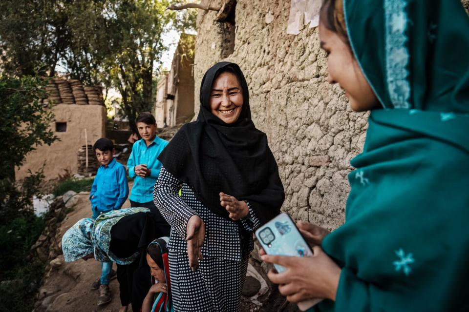 Zahra Wafa, center, leads her daughters with chores in the backyard of their home.