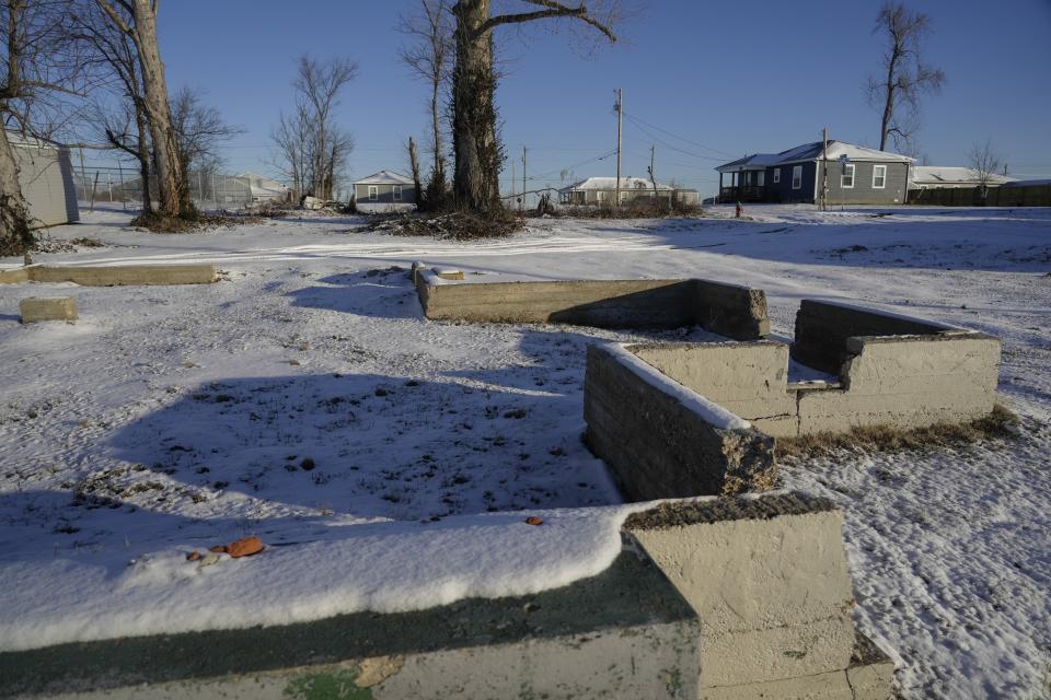 The foundation of a rental home where Ashley Prince lived with her family remains, Wednesday, Jan. 17, 2024, in Mayfield, Ky. Two years after the tornado outbreak that killed dozens and leveled much of the real estate in Mayfield, many people, like the Prince family, are still living through another, slower disaster, the search for housing. (AP Photo/Joshua A. Bickel)