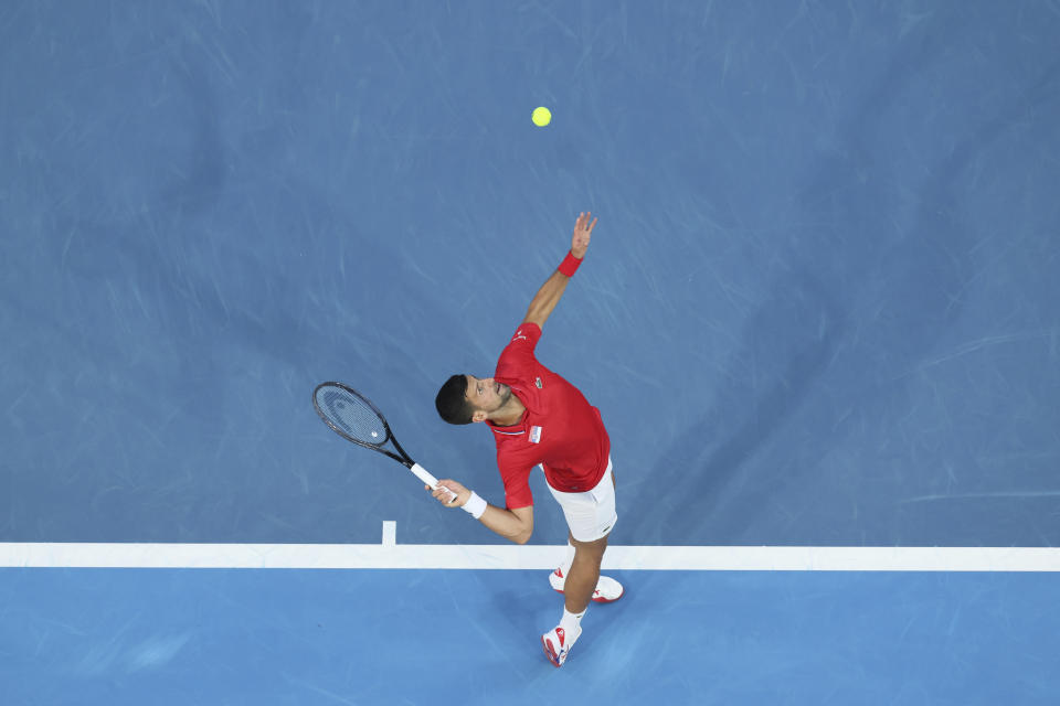 Novak Djokovic of Serbia serves to Zhizhen Zhang of China during the United Cup tennis tournament in Perth, Australia, Sunday, Dec. 31, 2023. (AP Photo/Trevor Collens)
