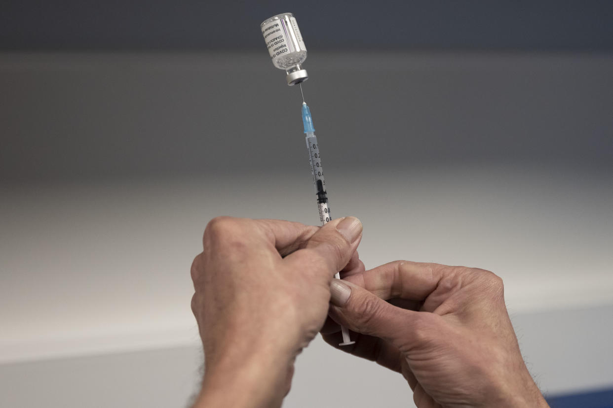 BARRY, WALES - MARCH 02: A health worker prepares the AstraZeneca Covid-19 vaccine vaccine at a mass vaccination centre at Holm View Leisure Centre on March 2, 2021 in Barry, Wales. One million doses of the coronavirus vaccine have been administered across Wales and more than one in three of the Welsh adult population have received at least one dose. Wales aims to have offered vaccinations to every eligible adult by July 31. (Photo by Matthew Horwood/Getty Images)