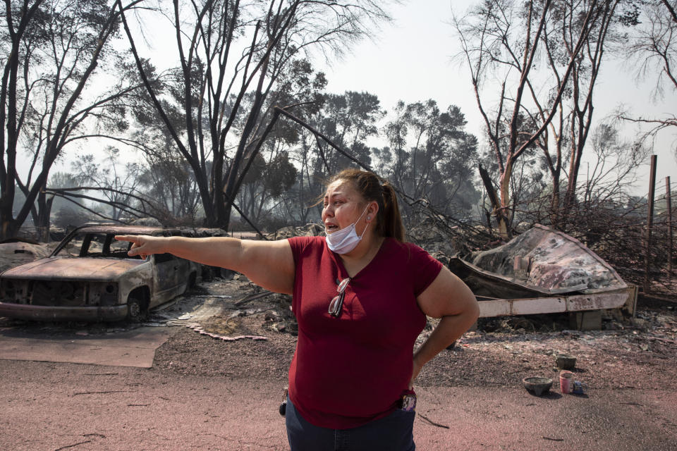 Maria Centeno from Mexico, reacts after seeing her destroyed mobile home at the Talent Mobile Estates as wildfires devastate the region on Thursday, Sept. 10, 2020 in Talent, Ore. (AP Photo/Paula Bronstein)