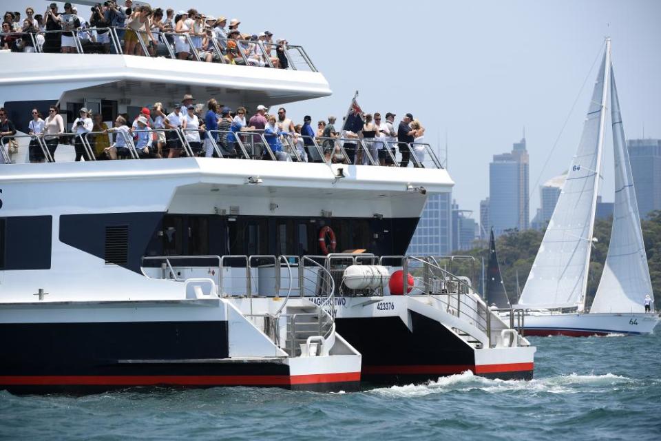 Spectators cram onto a boat in Sydney Harbour at the start of the 2019 race