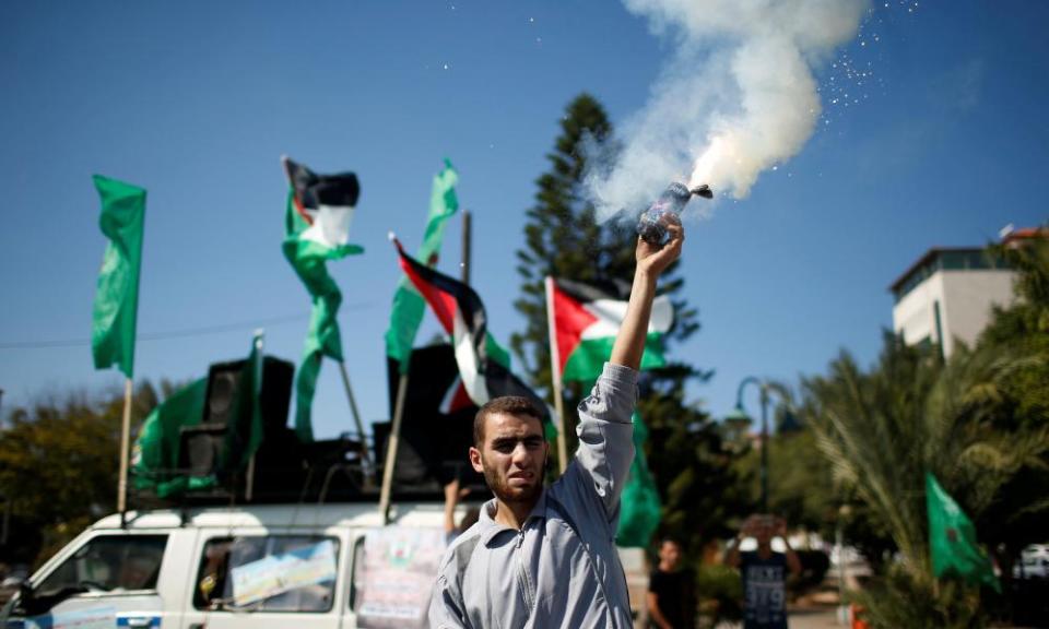 A Palestinian man releases fireworks in Gaza during celebrations after Hamas said it reached a deal with Palestinian rival Fatah.