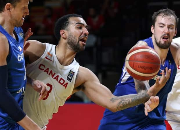 Trey Lyles, centre, can't hold on to the ball as Ondrej Balvin of the Czech Republic defends during Canada's 103-101 overtime loss at a last-gasp Olympic qualifying tournament in Victoria on Saturday. (Chad Hipolito/The Canadian Press - image credit)