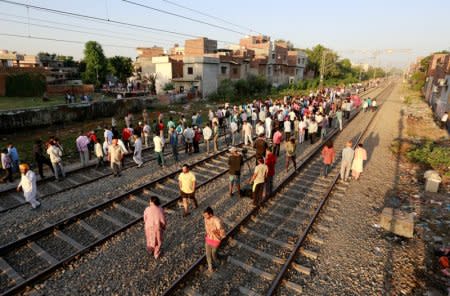 People gather at the site of an accident after a commuter train traveling at high speed ran through a crowd of people on the rail tracks on Friday, in Amritsar, India, October 20, 2018. REUTERS/Adnan Abidi