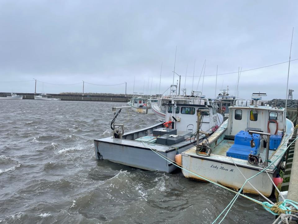 Strong surf hits boats tied up at the wharf in Pointe-Sapin, N.B., early Saturday afternoon.